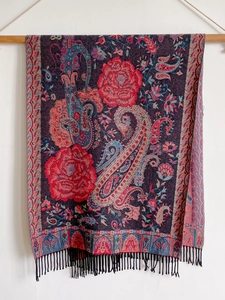 Detail of dark blue and red cashmere-feel scarf featuring paisley patterns and black tassels