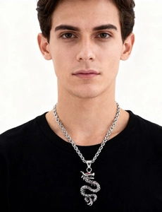 Close-up of vintage silver dragon pendant with red eyes on a male model's neck