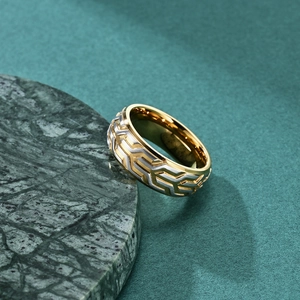Men's two-tone tire tread ring in gold and silver finish on green marble background
