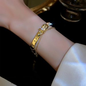 Macro detail of gold belt buckle bracelet with pavé cubic zirconia and adjustable link chain