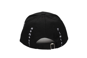 Detail of black cotton baseball cap showing silver buckle and white side embroidery
