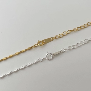 Macro shot of 925 sterling silver square chain links with a spring ring clasp closure