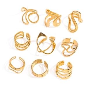 Collection of nine modern abstract gold plated stainless steel rings in varied wavy designs