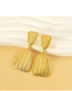 Close-up of gold-plated titanium steel earrings with a detailed woven texture