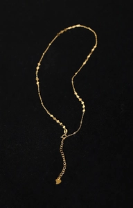 Macro detail of gold-plated titanium steel necklace with interconnected heart shaped links