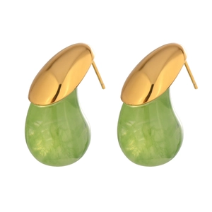 Detailed close-up of teardrop earrings with gold metal and green translucent resin