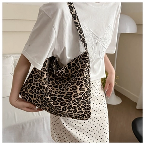 Detailed shot of a nylon leopard print tote bag styled with a casual summer outfit