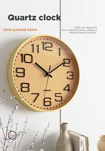 Detail of 12-inch wall clock with 5mm thin gold frame and 3D numbers on a white wall