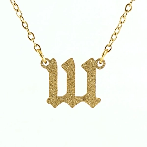 Detail of gold necklace featuring a 111 number pendant with a fine glitter frosted finish