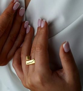 Close-up of a minimalist gold S925 silver geometric square and rectangle cross ring
