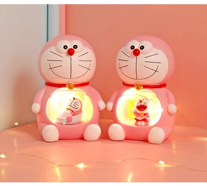Detail of pink Doraemon resin night lights with warm glow and cute interior scenes
