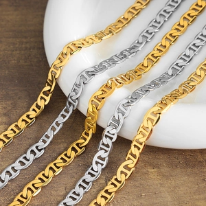Golden and silver mariner chain necklace in 18k gold plated copper on white ceramic