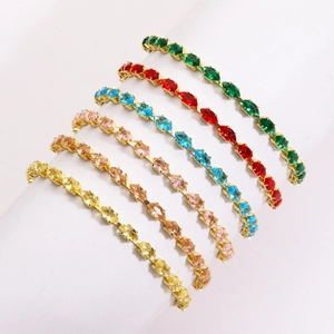 Macro detail of colorful marquise-cut zircon stones on thin gold-plated tennis bracelets