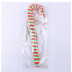 Detail of red and white candy cane ornament with green stripes and rustic hanging twine