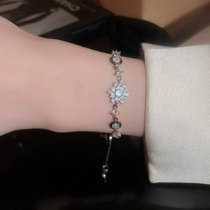 Detail of adjustable silver snowflake bracelet featuring sparkling zircon micro-paving