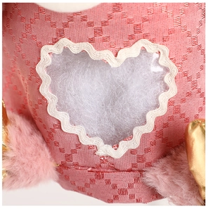 Detail of pink quilted apple bag with heart window and plush trim for Christmas gift packaging