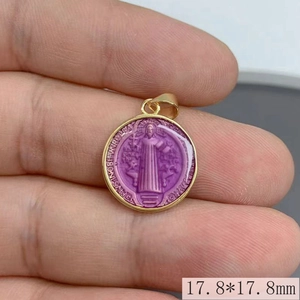 Macro view of 17.8mm purple and gold Saint Benedict medal pendant with Latin engraving
