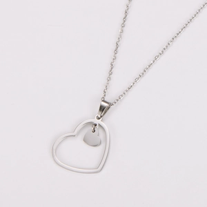 Detail of silver hollow heart pendant showing polished metallic shine and elegant design