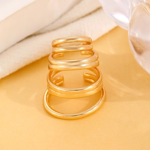 Macro detail of minimalist gold multi-layered ear cuffs with high-polished metal finish