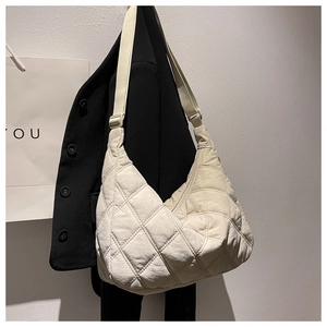 Beige quilted hobo bag in soft fabric with adjustable strap and large capacity