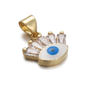 Macro shot of gold crown pendant with evil eye enamel and clear baguette cut zircons