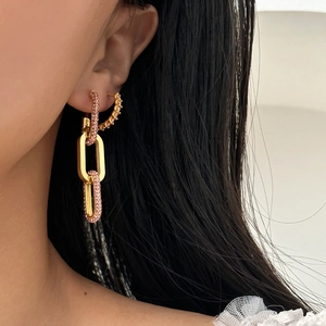 Chic gold rectangular geometric drop earrings with pink zircons worn by model