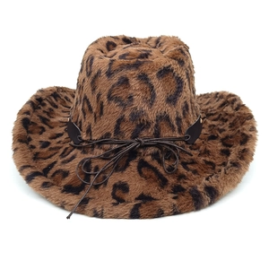 Close-up of leopard print faux fur texture and black leather bow detail on cowboy hat