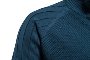 Detailed close-up of dark blue knit sweater showing shoulder stitching and ribbed neckline