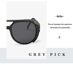 Detail of black sunglasses with yellow splatter art and Grey Pick branding logo