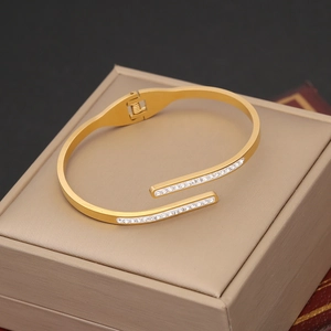 Detailed view of a gold-plated open bangle featuring rows of sparkling pavé cubic zirconia