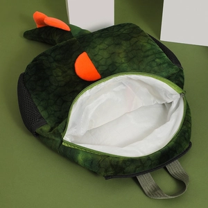 Detail view of the open plush dinosaur backpack showing the internal storage space