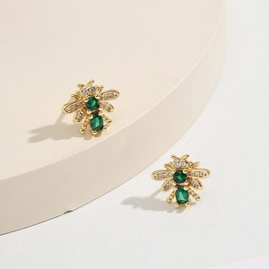 Exquisite gold bee earrings with green gemstone bodies and sparkling zircon wings