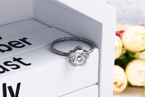 Macro shot of titanium flower nose ring with zircon on a decorative gift box