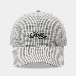 Detail of checkered baseball cap featuring Dorie embroidery and refined plaid texture