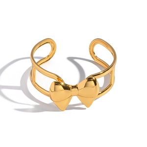 Polished 18K gold stainless steel open bangle featuring a hollow bow-knot design