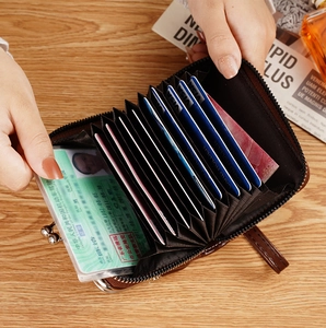 Detailed view of dark brown leather wallet with accordion card slots and ID window
