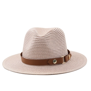 Detailed view of woven straw texture and classic brown leather belt with metal buckle