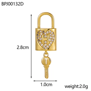 Detail view of heart-shaped gold padlock pendant with H and T initials and dimensions