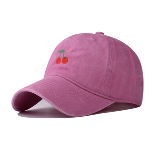Close-up of vintage washed pink baseball cap with red cherry embroidery detail