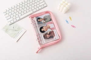 Detailed view of pink PVC binder with clear inner pockets for photos and card storage