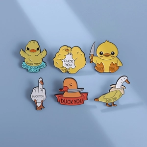 Detail view of 6-piece funny enamel duck pins set with colorful banana and knife designs