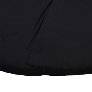 Detailed close-up of smooth black satin fabric texture and premium hem finish on a dress