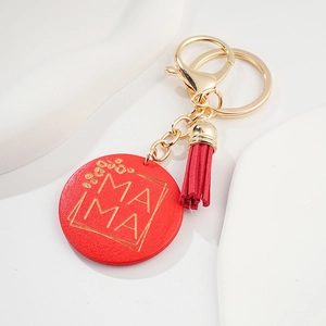 Detail of red MAMA round keychain featuring leopard print accents and matching tassel