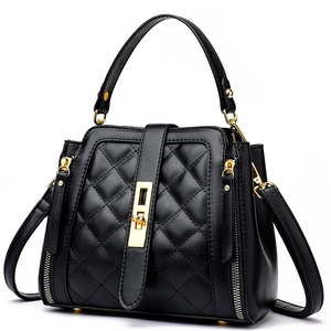 Chic black quilted bucket bag with gold hardware and stylish top handle for women