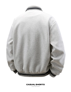 Detail showing grey knit varsity jacket back with black and white striped ribbed trim