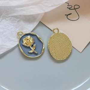 Detailed macro view of vintage gold rose pendants with blue enamel and pearl inlay details