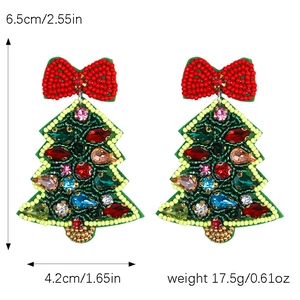 Detail view of handmade beaded Christmas tree earrings with red bow and size dimensions