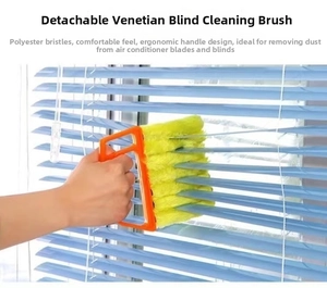 Detail of washable microfiber blind cleaner brush cleaning blue shutters on a window