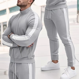 Detail of light grey tracksuit with white stripes and stand collar on model