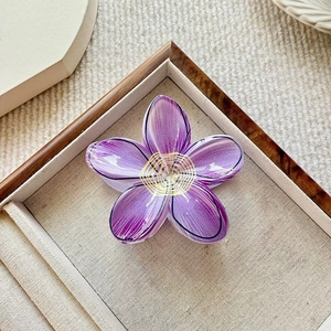 Elegant purple plumeria flower hair claw clip with glossy finish for stylish hair accessory